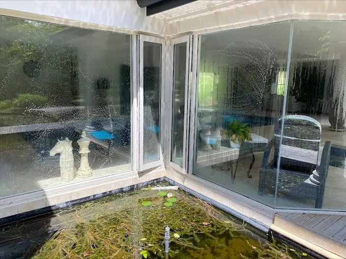 Bi-fold windows mid-clean at an Adelaide home